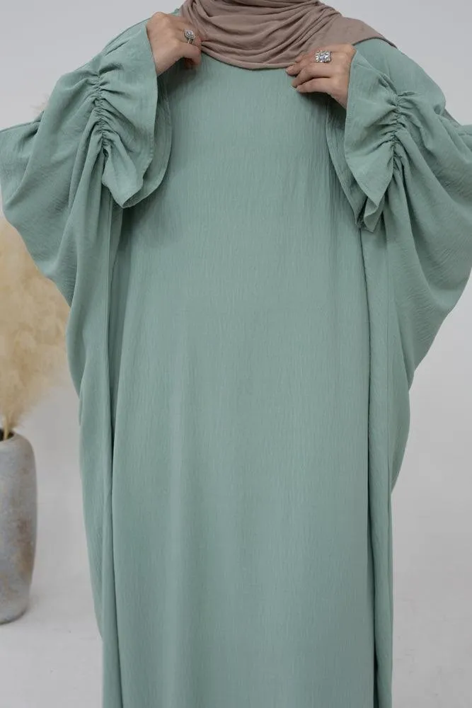 Radwa batwing abaya with ruched sleeve and loose cut in mint green